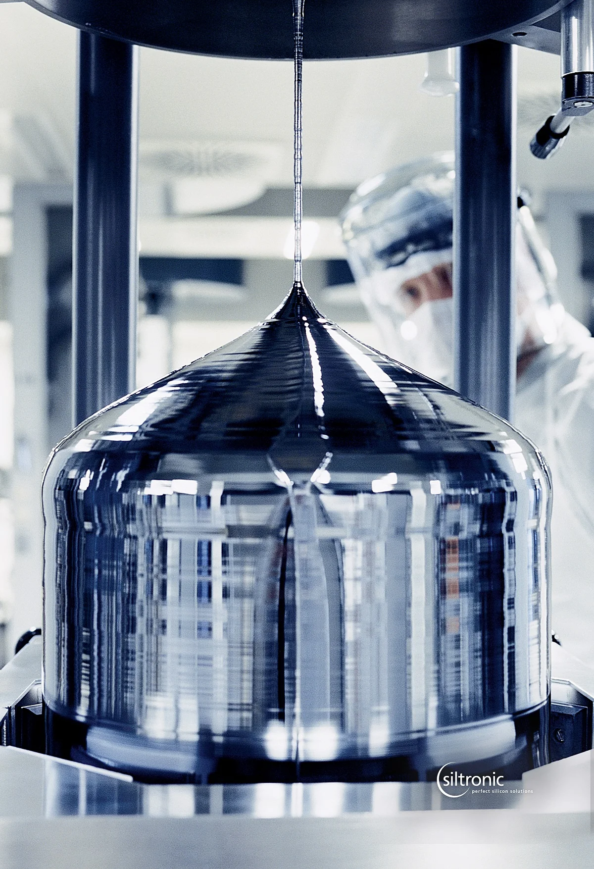 Close-up showing a large crystal inside a reactor, with the conical lid visible above