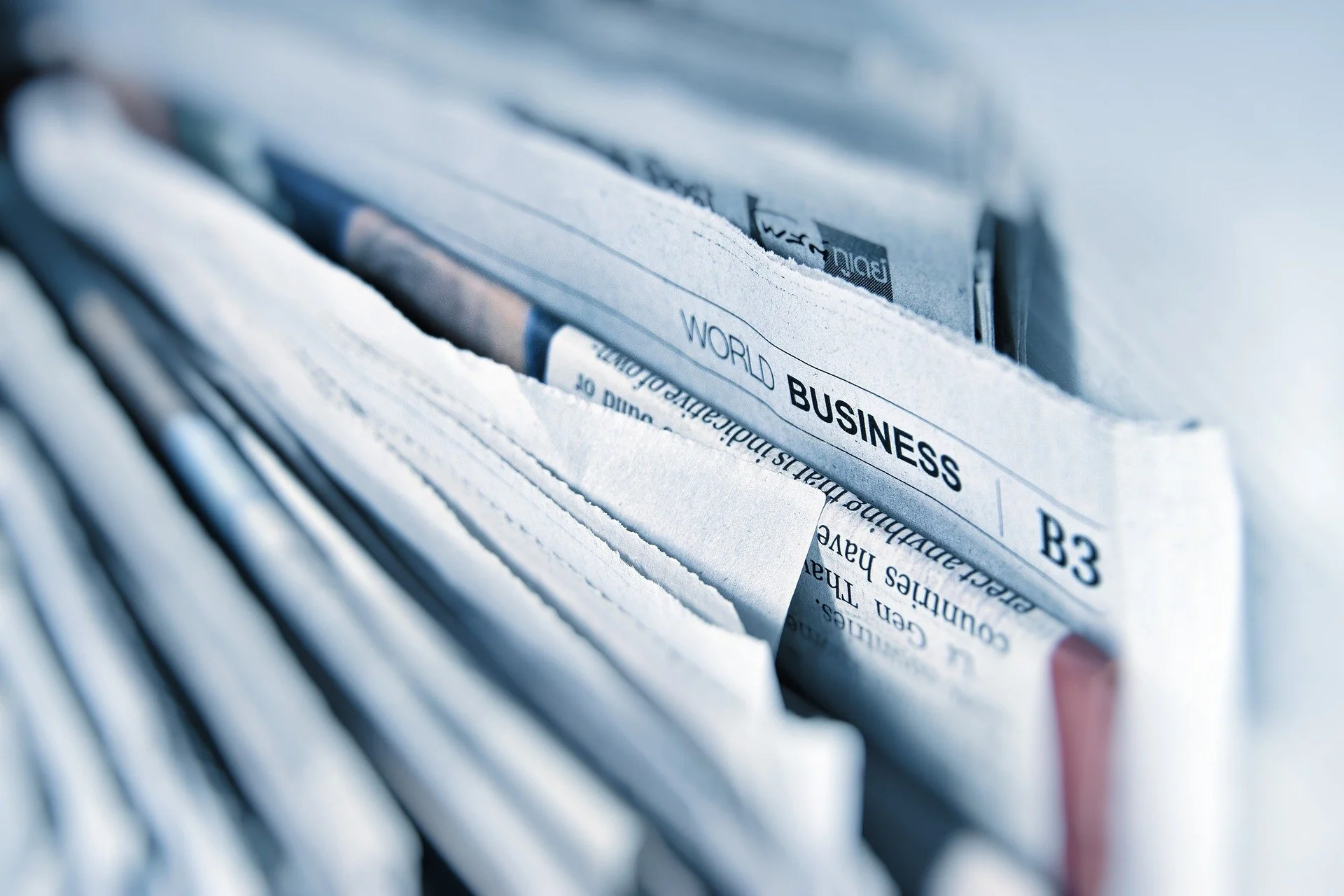 Stack of folded newspapers representing media and publications