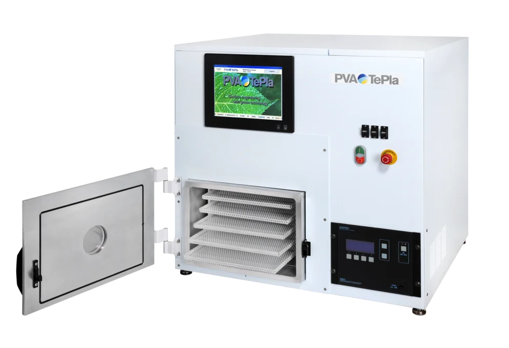 Compact plasma processing unit with door open to reveal multiple loading trays and a touchscreen display