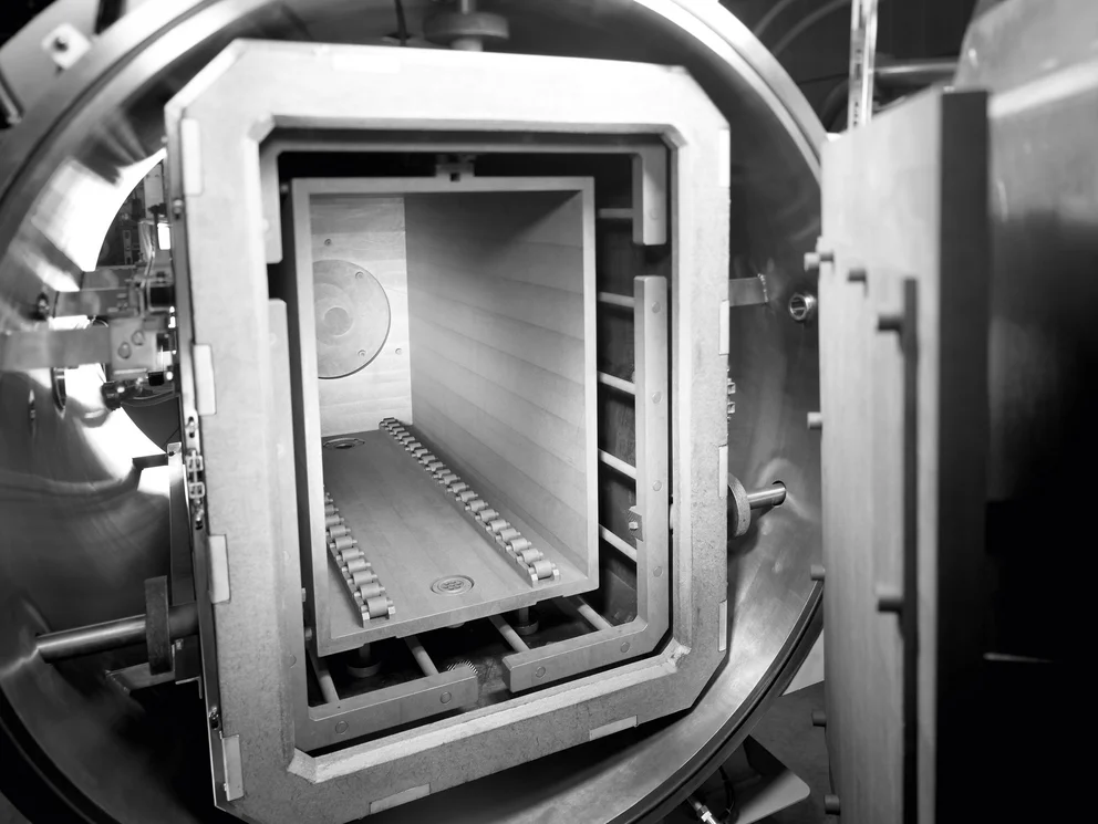 View into a vacuum sintering furnace with open door.