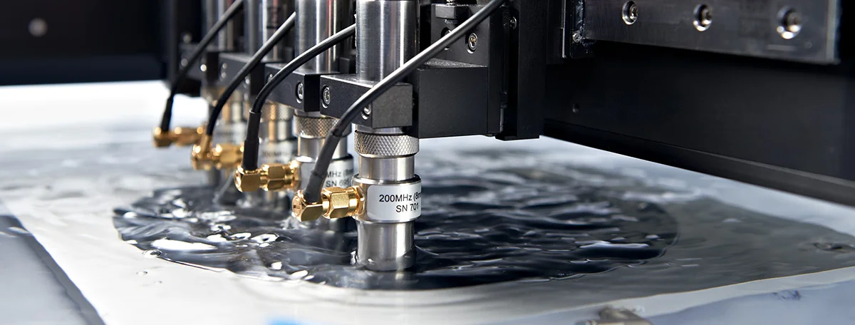 SAM system with multiple transducers inspecting a semiconductor wafer.