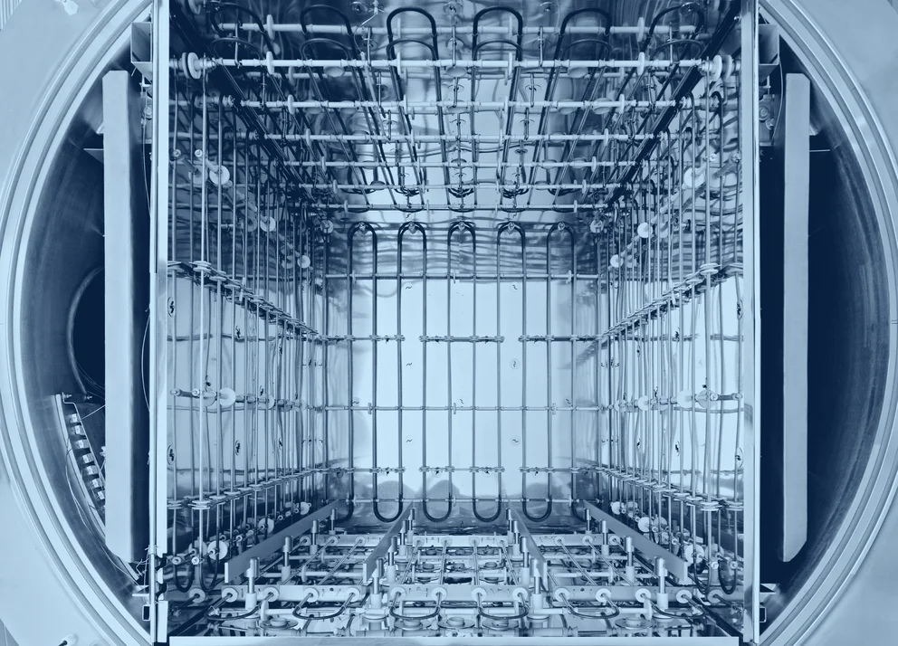Vacuum brazing furnace with an open chamber and internal heating elements visible